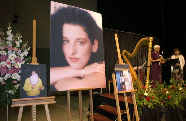 In this May 28, 2002, file photo, photographs of Chandra Levy are on display as musicians, right, stand by at a memorial service for Levy at the Modesto Centre Plaza in Modesto, Calif.