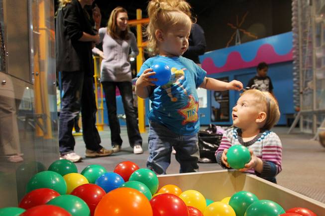 Eve Ostro, left, and Audrey Wade play with plastic balls and each other at Lied Discovery Childrens Museum Saturday, Jan. 26, 2013.