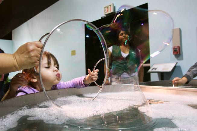 Kenzie Perez blows bubbles at Lied Discovery Children's Museum Saturday, Jan. 26, 2013.