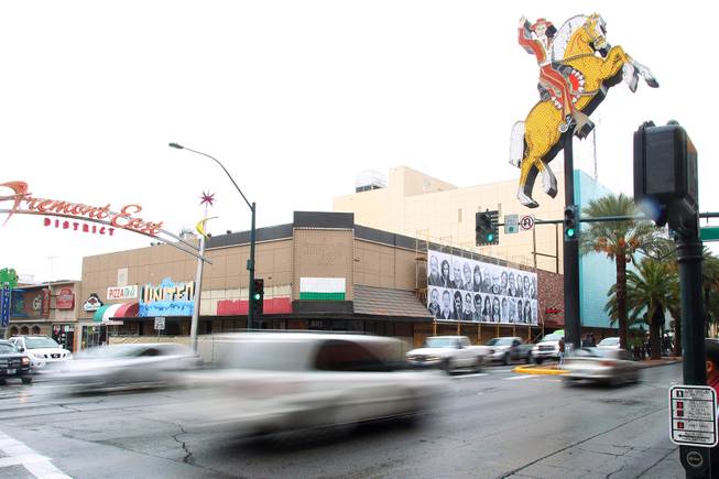 While a space that formerly housed a 7-Eleven store on the corner of Fremont St. and the Strip undergoes renovations, a mural of photos hangs on the scaffolding Saturday, Jan. 26, 2013.