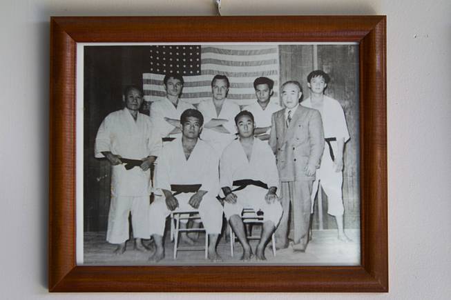 Dan Sawyer (standing, second left) poses in a 1947 photo of the Honolulu Police Department judo team. Sawyer, Shorin-ryu karate master, teaches in a garage behind his home that has been converted into a karate dojo.