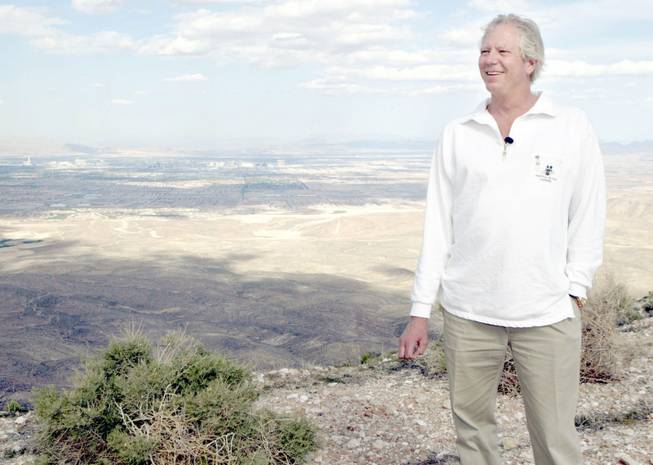 Developer Jim Rhodes smiles on Blue Diamond Hill Monday, May 5, 2003. Las Vegas can be seen in the background. Rhodes plans to develop the property, the site of the Jim Hardie Gypsum Mine,  into a residential community, he said.