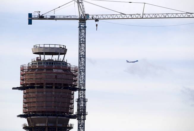 Air Force One flies past the Federal Aviation Administration (FAA) control tower under construction at McCarran International Airport after President Barack Obama kicked off his public push for immigration reform in Las Vegas, Nevada Tuesday, Jan. 29, 2013.