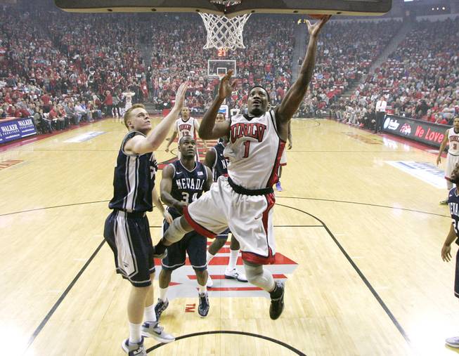 UNLV forward Quintrell Thomas lays in two points while being defended by UNR forward Kevin Panzer during their game Tuesday, Jan. 29, 2013 at the Thomas & Mack. UNLV won the game 66-54.