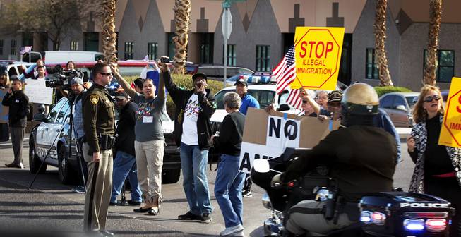 Protesters demonstrate outside of Del Sol High School in Las Vegas where President Barack Obama will speak about immigration reform on Tuesday, January 29, 2013.