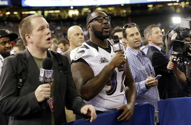 Baltimore Ravens defensive end Arthur Jones acts like a reporter during media day for the NFL Super Bowl XLVII football game Tuesday, Jan. 29, 2013, in New Orleans. 