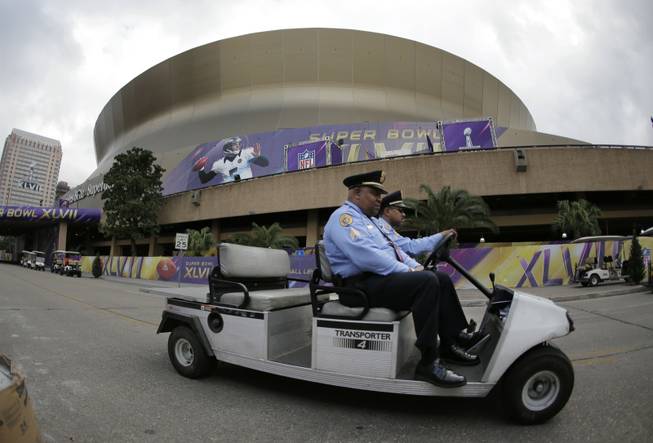 New Orleans police officers drive past the Superdome where the San Francisco 49ers and the Baltimore Ravens will play the NFL Super Bowl XLVII football game, Tuesday, Jan. 29, 2013, in New Orleans. 