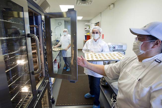 Jane Lee, right, owner and president of Jadon Foods, holds an oven door for Ahsley Money at the bakery with a tray of gluten-free cookies Wednesday, Jan. 30, 2013. Jadon Foods is a gluten-free bakery that also specializes in diabetic-friendly and dairy-free baked goods.