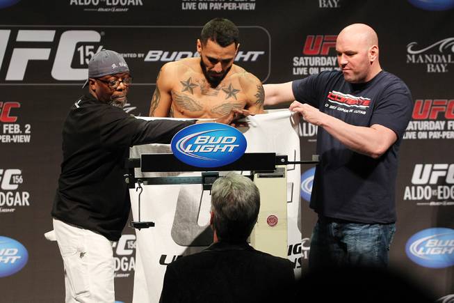 Burt Watson and UFC president Dana White hold up a towel after Francisco Rivera dropped his underwear trying to make weight during weigh ins for UFC 156 Friday, Feb. 1, 2013. Neither Rivera nor challenger initially made weight