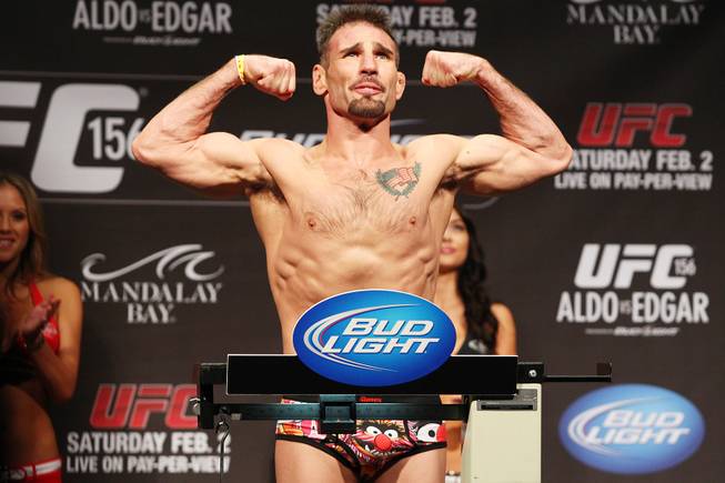 Isaac Vallie-Flagg flexes during weigh ins for UFC 156 Friday, Feb. 1, 2013.