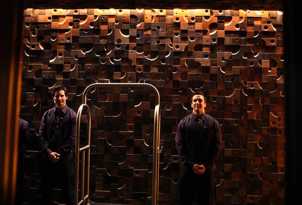 Bellmen Zerin Marglin, left, and Daniel Walter wait in the lobby of the new Nobu Hotel at Caesars Palace in Las Vegas on Friday, February 1, 2013.