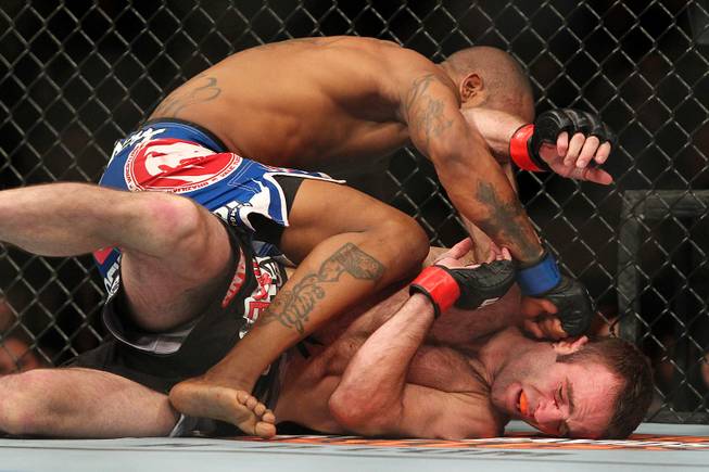 Jacob Volkmann absorbs a right from Bobby Green during their bout at UFC 156 Saturday, Feb. 2, 2013 at the Mandalay Bay Events Center. Green won via submission in the third round.