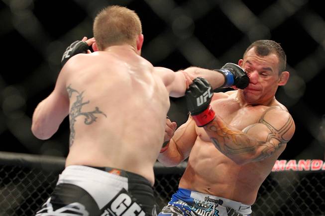 Gleison Tibau gets hit with a right from Evan Dunham during their bout at UFC 156 Saturday, Feb. 2, 2013 at the Mandalay Bay Events Center. Dunham won a split decision.