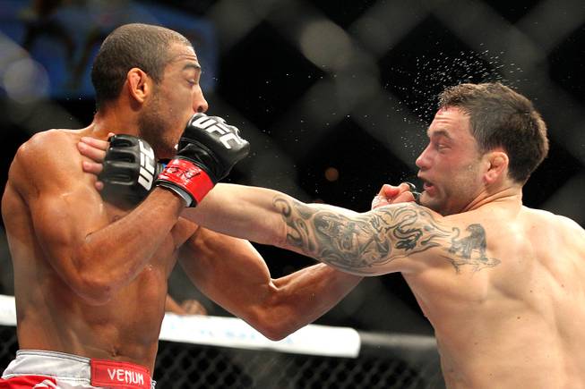 Jose Aldo catches Frankie Edgar with a left during their featherweight title fight at UFC 156 Saturday, Feb. 2, 2013 at the Mandalay Bay Events Center. Aldo retained his title with a unanimous decision.