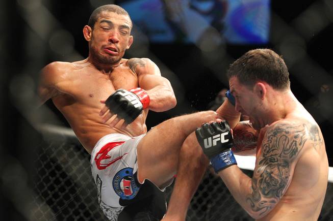 Jose Aldo throws a knee at Frankie Edgar during their featherweight title fight at UFC 156 Saturday, Feb. 2, 2013 at the Mandalay Bay Events Center. Aldo retained his title with a unanimous decision.