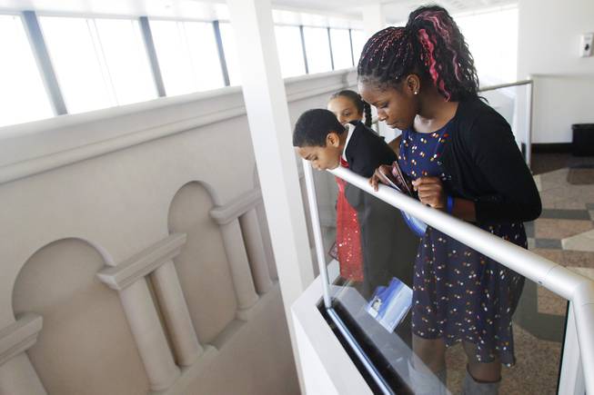 Assemblyman William Horne's children, from left, Chloe, Henry and Quyncee Horne, take in the view from a fourth floor railing of the Nevada Legislative Building on the first day of the 2013 legislative session Monday, Feb. 4, 2013 in Carson City.