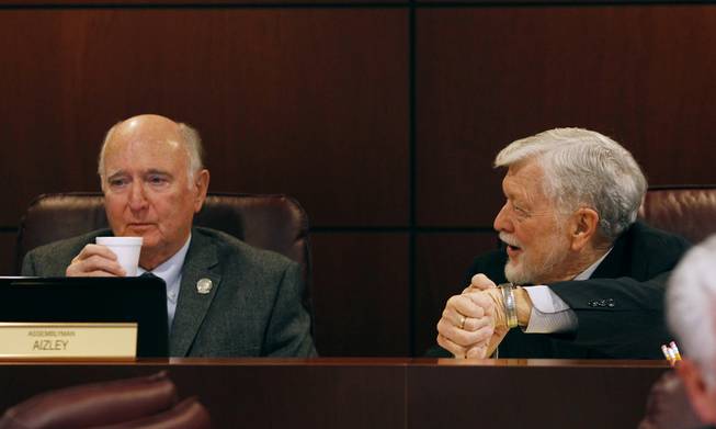 Assemblymen Paul Aizley and Joe Hogan chat during a meeting of the Ways and Means Committee on the second day of the 2013 legislative session Tuesday, Feb. 5, 2013 in Carson City.