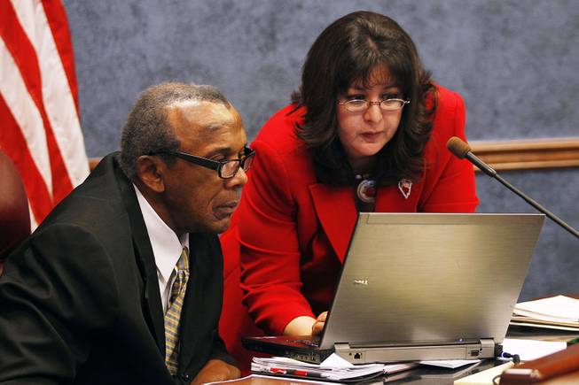 Assemblyman Harvy Munford and Irene Bustamante Adams look at a computer during a meeting of the Government Affairs Committee on the second day of the 2013 legislative session Tuesday, Feb. 5, 2013 in Carson City.
