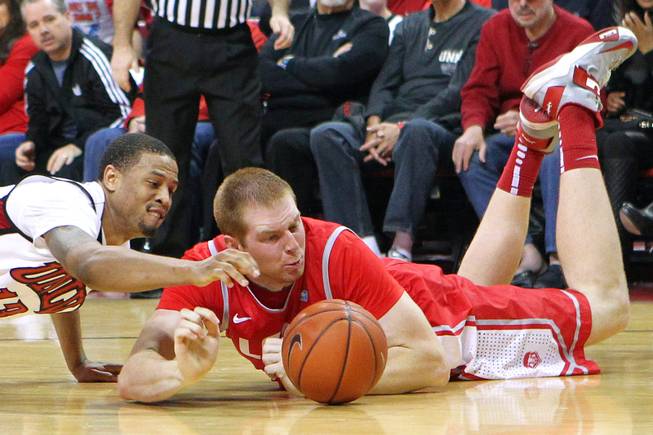 UNLV guard Bryce Dejean-Jones and New Mexico center Alex Kirk chase a loose ball during their game Saturday, Feb. 9, 2013 at the Thomas & Mack Center. UNLV beat New Mexico 64-55.