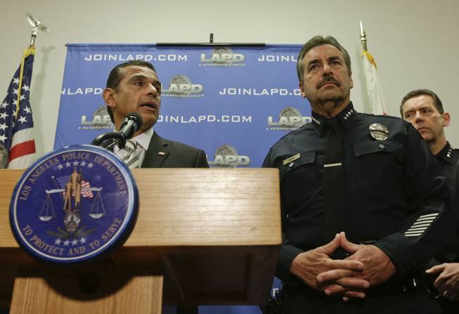 Los Angeles Mayor Antonio Villaraigosa, left, talks about the $1 million reward for accused killer and fired Los Angeles police officer Christopher Dorner as Los Angeles Police Chief Charlie Beck looks on during a news conference at the Los Angeles police department in Los Angeles on Sunday, Feb. 10, 2013.