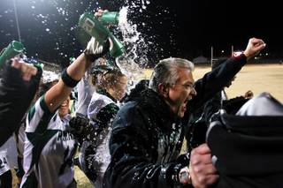 Palo Verde head coach Kevin Hagood is doused with water as the clock expires during their district championship flag football game against  Silverado Wednesday, Feb. 13, 2013. Palo Verde won the game 7-6.