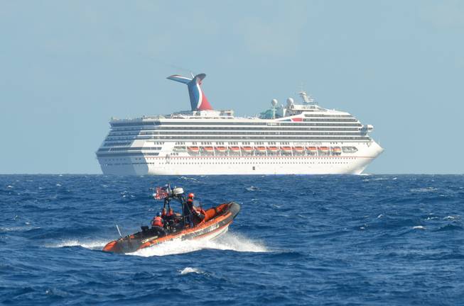 In this image released by the U.S. Coast Guard on Feb. 11, 2013, a small boat belonging to the Coast Guard Cutter Vigorous patrols near the cruise ship Carnival Triumph in the Gulf of Mexico, Feb. 11, 2013. 