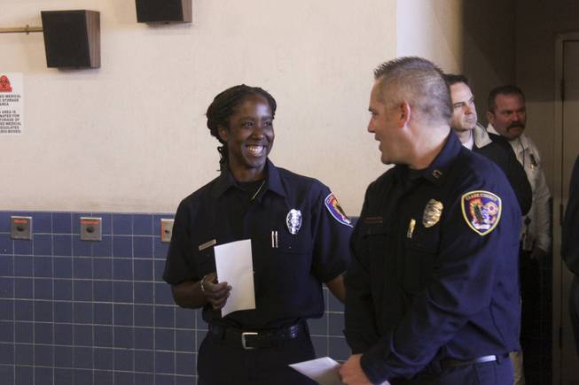 Newly promoted Fire Engineer Jennifer Osborne and  Fire Captain Darren Morville exchange a smile after a ceremony honoring Osborne, Friday, Feb. 15, 2013.  Osborne is the first black female to be promoted to Fire Engineer in the Clark County Fire Department.