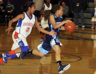 Tramina Jordan dribbles past Gael defender April Rivers as the schools faced off in the Sunset Regional championship game at Durango High School on Friday night.