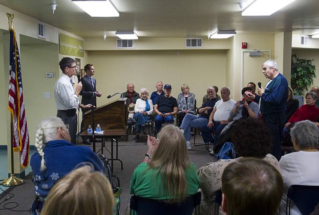 Congressman Joe Heck, left, (R-NV) listens to a questioner during a town hall meeting with constituents at Pacific Pines Senior Apartments in Henderson Tuesday, Feb.19, 2013.