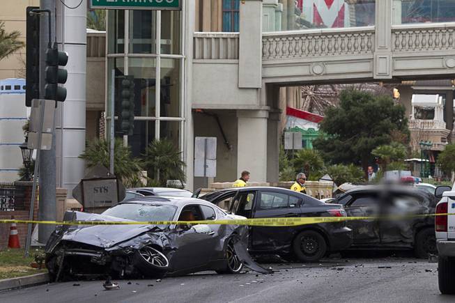 Wrecked cars are shown on Las Vegas Boulevard and Flamingo Avenue as Las Vegas Metro Police investigate a shooting and multi-car accident that left three people dead and three injured on the Las Vegas Strip early Thursday morning, Feb. 21, 2013. EDITOR’S NOTE: This photo has been digitally altered to obscure an image of one of the victims.
