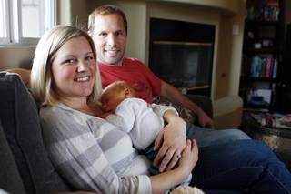 Lisa and Brent Stark sit with their newborn Will Thursday, Feb. 21, 2013. Lisa had Will's placenta dried and turned into pill form for her to take to avoid postpartum depression.