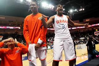 Bishop Gorman's Robert Stanley (2) jumps on a court side table to celebrate their 69-43 Division I state championship win over Centennial Friday, Feb. 22, 2013 at the Orleans.