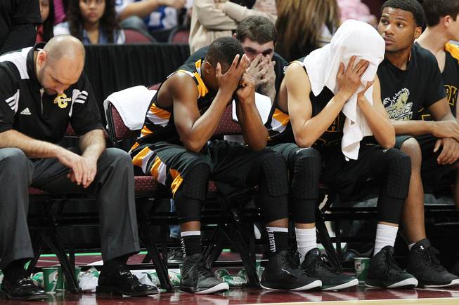 Clark players and coaches sit stunned on the bench after losing to Clark in their Class 1A basketball championship game Saturday, Feb. 23, 2013 at the Orleans Arena. After trailing almost the whole game, Desert Pines came from behind to win 59-57