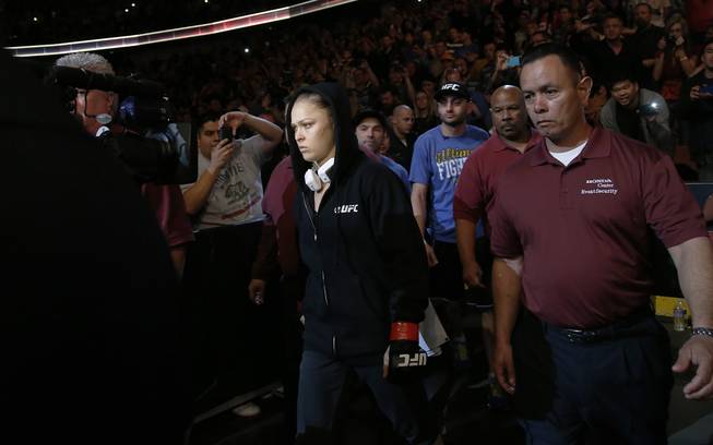 Ronda Rousey arrives for her UFC 157 women's bantamweight championship mixed martial arts match against Liz Carmouche in Anaheim, Calif., Saturday, Feb. 23, 2013. Rousey won the first womens bout in UFC history, forcing Carmouche to tap out in the first round. (AP Photo/Jae C. Hong)