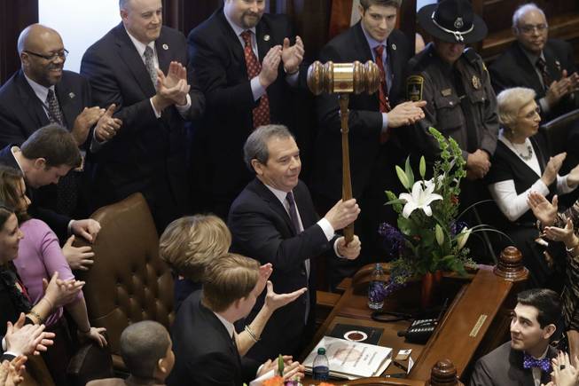 Illinois Senate President John Cullerton, D-Chicago, left, holds up an oversized gavel given to him by Sen. Martin Sandoval, D-Cicero, during swearing-in ceremonies on Senate floor at the Illinois State Capitol Wednesday, Jan. 9, 2013, in Springfield Ill. 