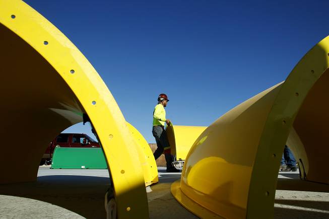 Workers assemble pieces of water slides for the new Wet 'n' Wild water park Wednesday, Feb. 27, 2013.