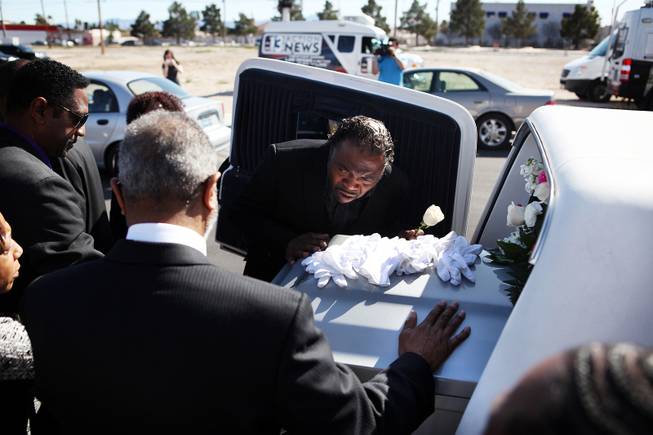 Tehran Boldon, Michael Boldon's brother, leans in to kiss his brother's coffin after the memorial service for Michael Boldon at Holy Trinity AME Church in North Las Vegas on Wednesday, Feb. 27, 2013. Boldon was killed in his cab Feb. 21, the result of a fiery crash after a shootout on the Las Vegas Strip.