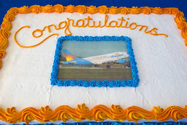 A cake decorated with a photo of a Allegiant Airbus A319 passenger jet is displayed as Allegiant Air employees get their first look at the new jet at McCarran International Airport Thursday, Feb. 28, 2013. The new jets are much more fuel efficient than the company's current jets.
