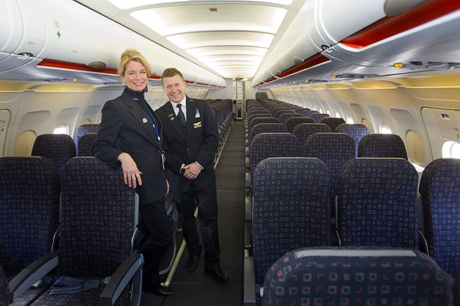 Theresa Mack, an inflight training instructor, and Allen Thieman, inflight manager for Las Vegas, pose in new Allegiant Air Airbus A319 passenger jet at McCarran International Airport Thursday, Feb. 28, 2013. The new jet is more fuel efficient than the company's current jets.