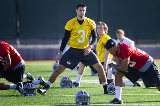 Quarterback Nick Sherry, center, exercises with the team during practice at Rebel Park at UNLV Monday, March 4, 2013.