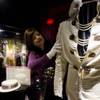 Archivist Dee Dee Antle adjusts one of Elvis Presley's famous jumpsuits during the opening of Graceland's newest exhibition in Memphis, Tenn., March 4, 2013. “Elvis: Live from Vegas”  features footage from some of "The King's" more memorable performances in Las Vegas and artifacts including Elvis' famous American Eagle jumpsuit.