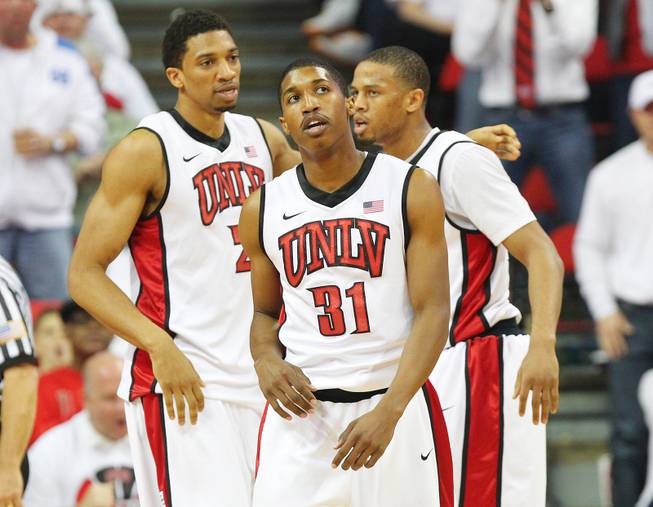 UNLV players from left, Khem Birch, Justin Hawkins and Bryce Dejean-Jones gather themselves during a break in action against Fresno State Saturday, March 9, 2013 at the Thomas & Mack Center. Fresno State upset UNLV 61-52.