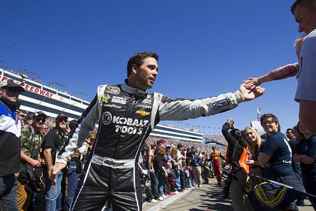 Driver Jimmie Johnson (48) greets a fan during driver introductions at the Kobalt Tools 400 NASCAR race at the Las Vegas Motor Speedway Sunday, March 10, 2013.