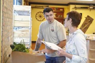 Tim McLaughlin, store manager, helps a customer at Trish & Ed's Organics, Wednesday, March 6, 2013.