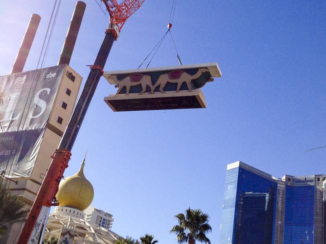 A crane lowers part of the Sahara sign during the dismantling of the casino sign, Tuesday, Mar. 12, 2013.