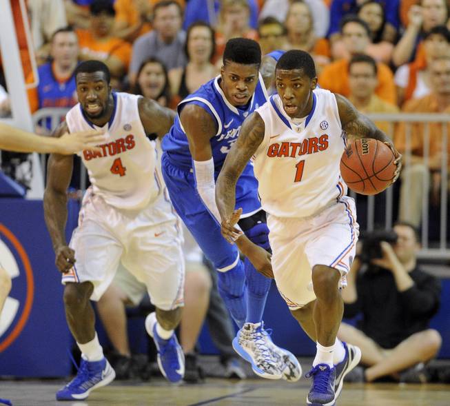 Florida guard Kenny Boynton (1) gets ahead of Kentucky forward Nerlens Noel (3) after getting possession of the ball and heads down court with teammate Patric Young (4) close behind during the first half of an NCAA college basketball game in Gainesville, Fla., Tuesday, Feb. 12, 2013. 