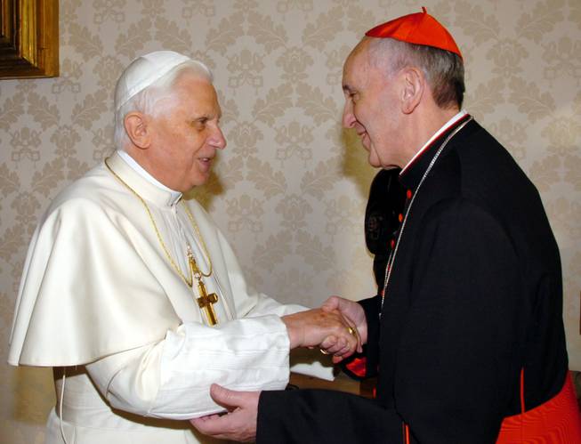 This Jan. 13, 2007 file photo provided by the Vatican newspaper L'Osservatore Romano, then Pope Benedict XVI, left, shakes hands with the archbishop of Buenos Aires Cardinal Jorge Mario Bergoglio during their meeting at the Vatican, Saturday, Jan. 13, 2007. Bergoglio, who took the name of Pope Francis,  was elected on Wednesday, March 13, 2013 the 266th pontiff of the Roman Catholic Church. 