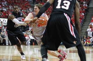 New Mexico forward Cameron Bairstow drives between San Diego State's DeShawn Stephens, left, and Winston Shepard during their Mountain West Conference Tournament game Friday, March 15, 2013 at the Thomas & Mack Center.