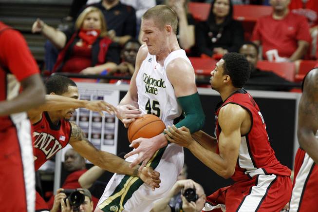 UNLV guard Anthony Marshall, left, and forward Khem Birch defend Colorado State forward Colton Iverson during their Mountain West Conference Tournament game Friday, March 15, 2013 at the Thomas & Mack Center.