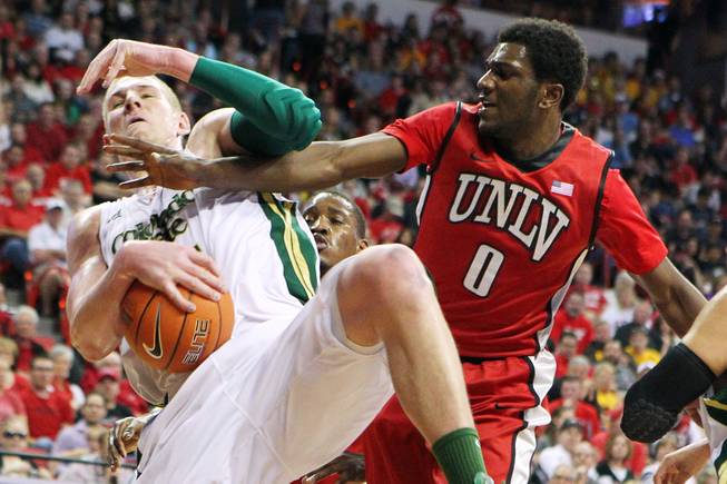 UNLV forward Savon Goodman reaches in on Colorado State forward Colton Iverson during their Mountain West Conference Tournament game Friday, March 15, 2013 at the Thomas & Mack Center. UNLV won 75-65 and will face New Mexico in the championship game on Saturday.